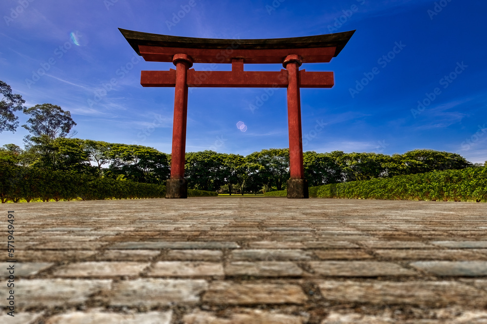 Torii, gate of Japanese shrine. 3D illustration of a wooden Japanese torii gate painted in red and black colors on a stone path with bushes on the side and trees in the background on a sunny day Torii, gate of Japanese shrine. 3D illustration of a wooden Japanese torii gate painted in red and black colors on a stone path with bushes on the side and trees in the background on a sunny day