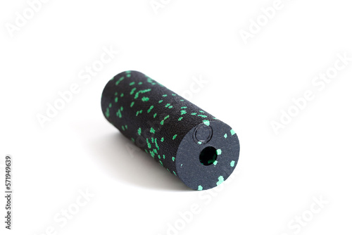 A black green massage foam roller mini isolated on a white background. Close-up. Foam rolling is a self myofascial release technique. Concept of fitness equipment. photo