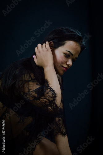Portrait of a beautiful young Brazilian woman in underwear fixing her hair with her hand