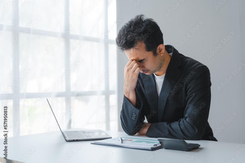 Young handsome asia business man in formal suit working with monthly report balance sheet and yearly tax of accounting to verify the account by an authorized auditor Young handsome asia business man in formal suit working with monthly report balance sheet and yearly tax of accounting to verify the account by an authorized auditor
