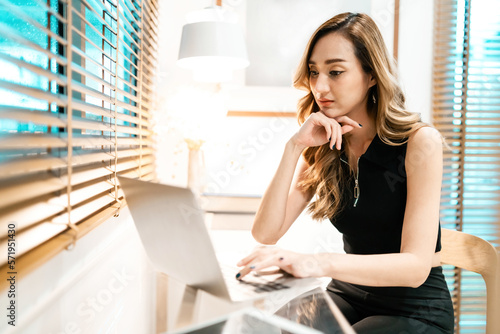 pretty woman bored thinking working laptop. gorgeous freelancer with office syndrome exhausted planning to finishing. pretty female worker have office syndrome work late having thought when to finish