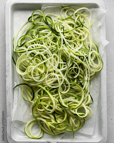 Zucchini Noodles Called Zoodles Freshly Spiralized on a White Parchment Sheet-Pan 