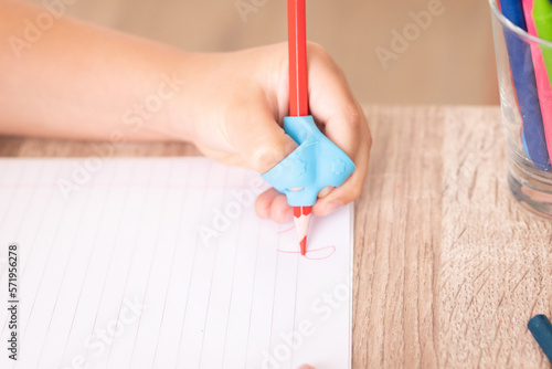 left hand holding a pencil adaptation