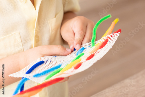 Both hands working together with pipe cleaner photo