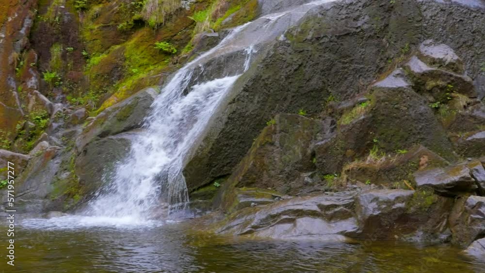 Establishing shot of majestic mountain waterfall with mountain background in Vancouver, Canada, North America. Day time on July 2022. Still camera view. ProRes 422 HQ. Establishing shot of majestic mountain waterfall with mountain background in Vancouver, Canada, North America. Day time on July 2022. Still camera view. ProRes 422 HQ.