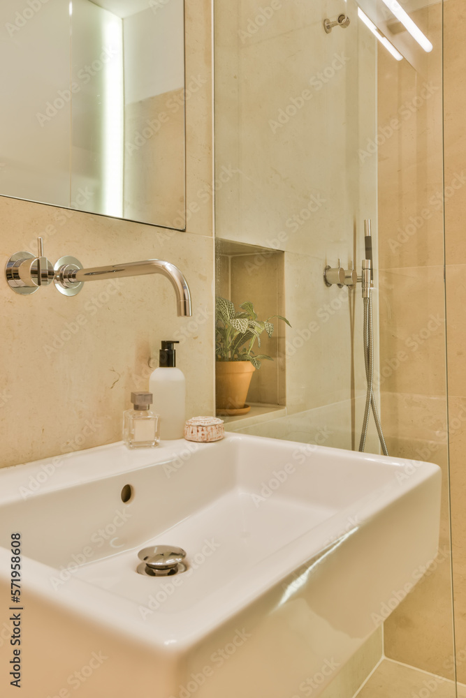 Modern bathroom with sink and green plant Modern bathroom with sink and green plant
