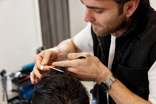 hairdresser does haircut for caucasian bearded man © producer