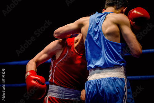boxing match two boxers in ring on black background © sports photos