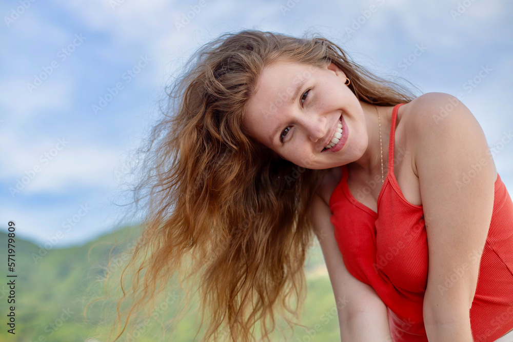 Portrait of happy beautiful young girl, dreams and meditation, relax nature, tanning on sun at summer sunny day on natural background with sky and mountains, breathing deep fresh air Portrait of happy beautiful young girl, dreams and meditation, relax nature, tanning on sun at summer sunny day on natural background with sky and mountains, breathing deep fresh air