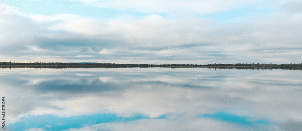 calm on a large lake, reflection of the sky in the water