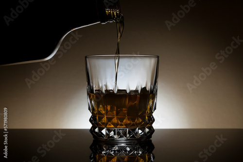 Backlit glass of whiskey photo