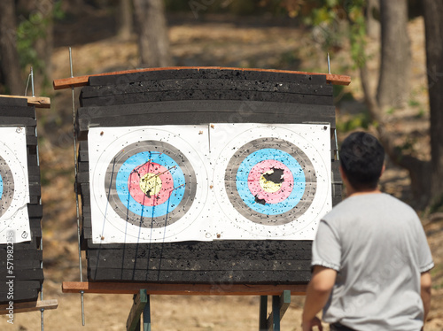 Man looking at arrow target