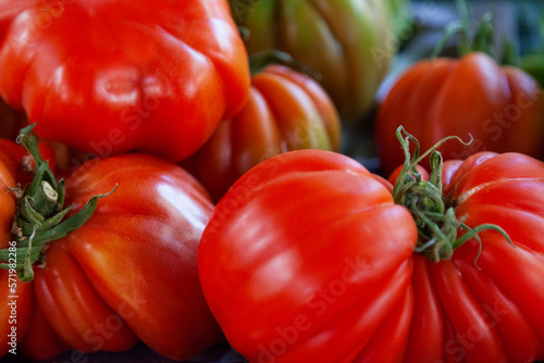 Stack of Beefsteak tomatoes on a market stall © BreizhAtao
