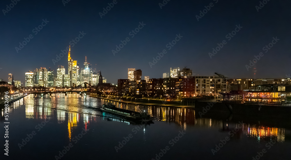 city skyline at night with the ship on the river
