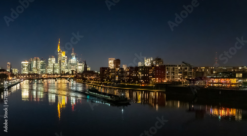 city skyline at night with the ship on the river