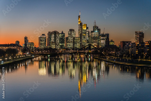 illuminated skyline at night reflecting in the river