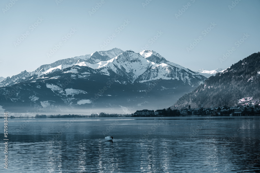 Amazing winter vibes at a lake in between snowy mountains in the alps