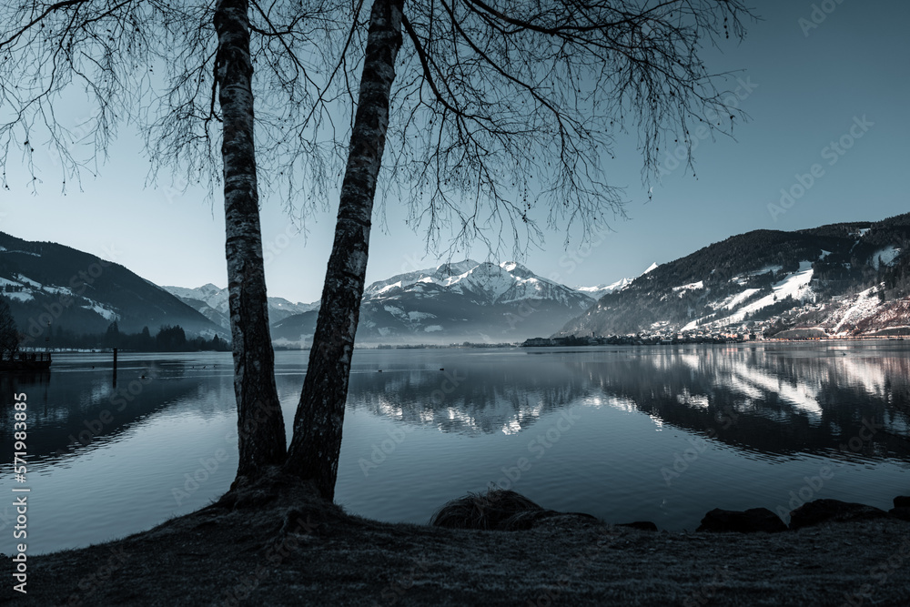 Amazing winter vibes at a lake in between snowy mountains in the alps