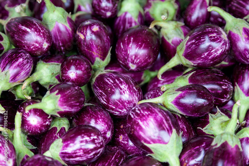Stack of small eggplants on a market stall