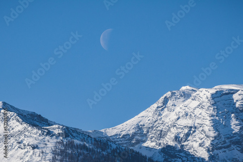 Moon in the morning with snowy alps