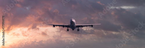 Turbojet airliner landing at sunset