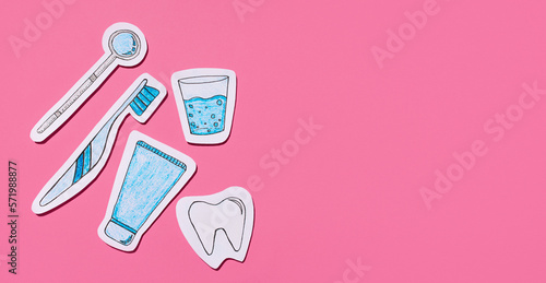 The concept of dentistry. Set for dental care cut out of paper on a pink background. Examination at the dentist. Flat lay, top view. Banner. Copy space.