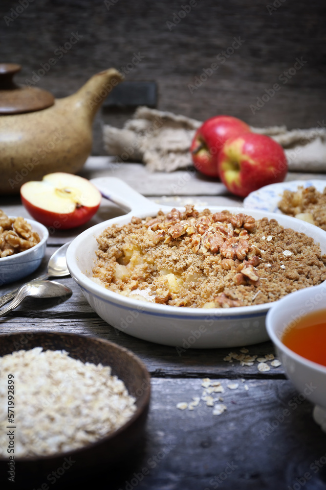 Fresh apple crumble from oatmeal, walnut dressing and cup of tea for healthy breakfast Fresh apple crumble from oatmeal, walnut dressing and cup of tea for healthy breakfast