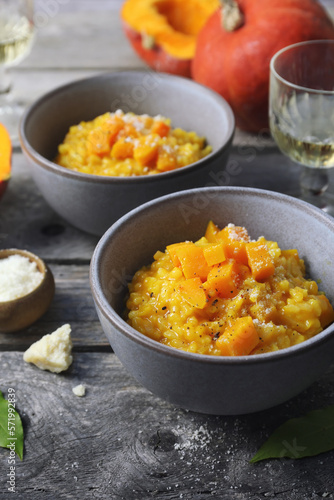 Italian food. Plate of pumpkin risotto and grated parmesan cheese