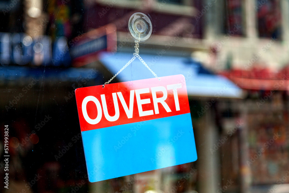 Open sign in French in a store window
