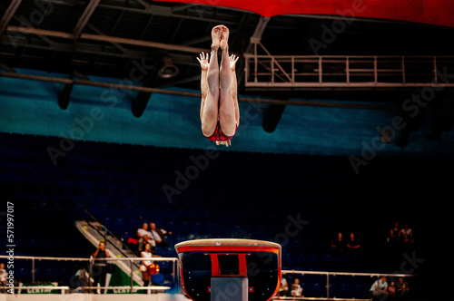female gymnast athlete exercise gymnastics vault in competition