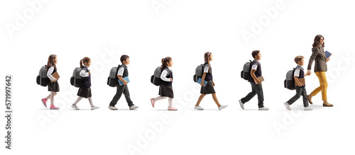 Teacher crossing a street with schoolchildren on a crosswalk photo