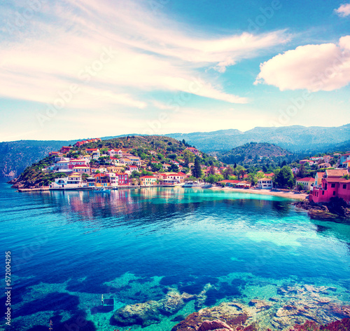 Obraz na płótnie Beautiful landscape with bay and colorful buildings on the background of picturesque clouds in the town of Asos, Greece, Kefalonia. Wonderful exciting places. w salonie