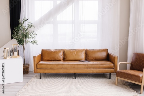 Minimalist living space leather couch big windows 