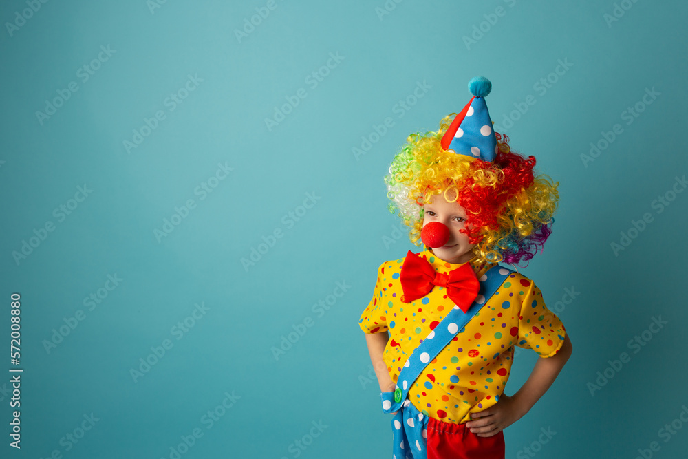 Funny kid clown against blue background. 1 April Fool's day concept