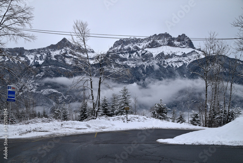 Winter landscape in the French Alps: mountain road and trees