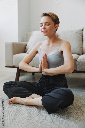 Woman exercising at home by video workout online, meditation and stretching, mental health © SHOTPRIME STUDIO