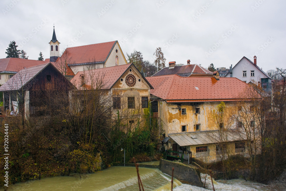 A wet December day in Skofja Loka in Gorenjska, Slovenia. The north shore of the Selska Sora river as it flows through the historic centre