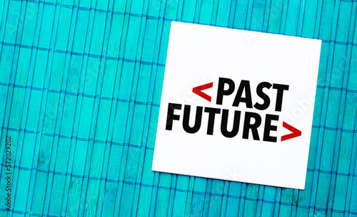 past future word on torn paper with blue wooden background