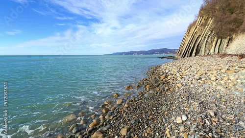 Sea waves on the Black Sea coast. Waves splash on the beach with pebbles in the rays of the sun. Sunset on the Black Sea. Panoramic view of the Black Sea. Kiseleva Rock, Russia, Agoi photo