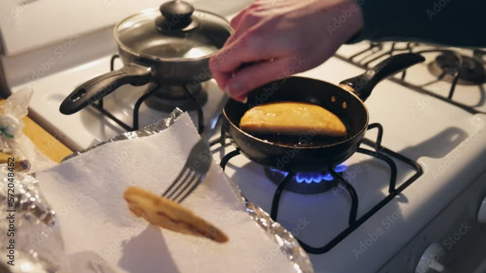 2 pieces of tortilla frying in a pan over low heat 2 pieces of tortilla frying in a pan over low heat