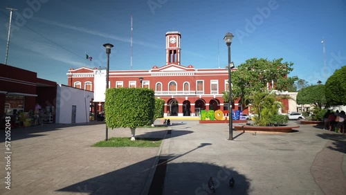 Push in to the Municipal Palace from the central park in Motul Yucatan Mexico. photo