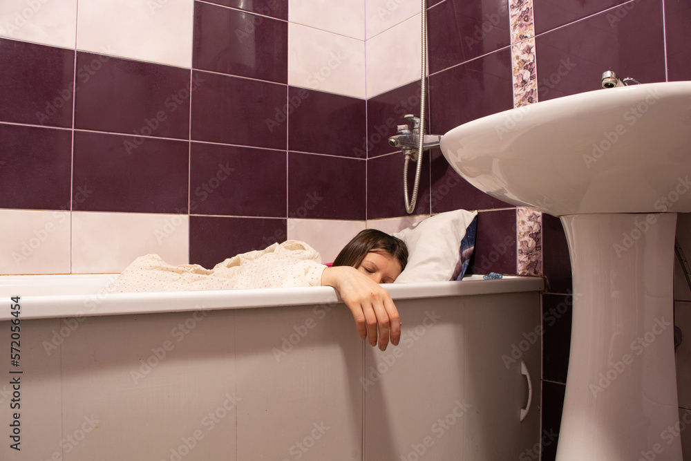 Ukrainian woman sleeps in the bathroom in the bathroom during a missile ...