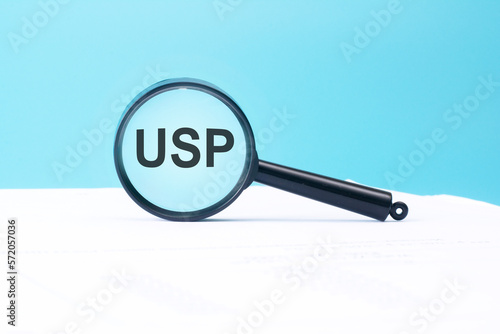 look at the text USP through a magnifying glass on a blue and white background