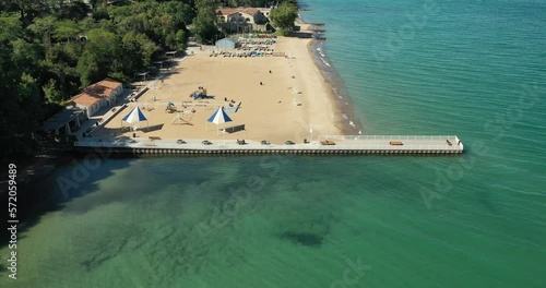 Large suburban public beach in Glencoe, Illinois with long pier along the Lake Michigan shoreline with sailboats and kayaks. photo