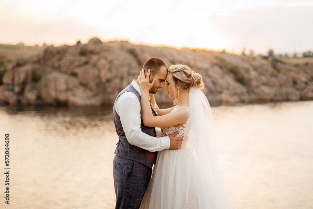 bride blonde girl and groom near the river bride blonde girl and groom near the river