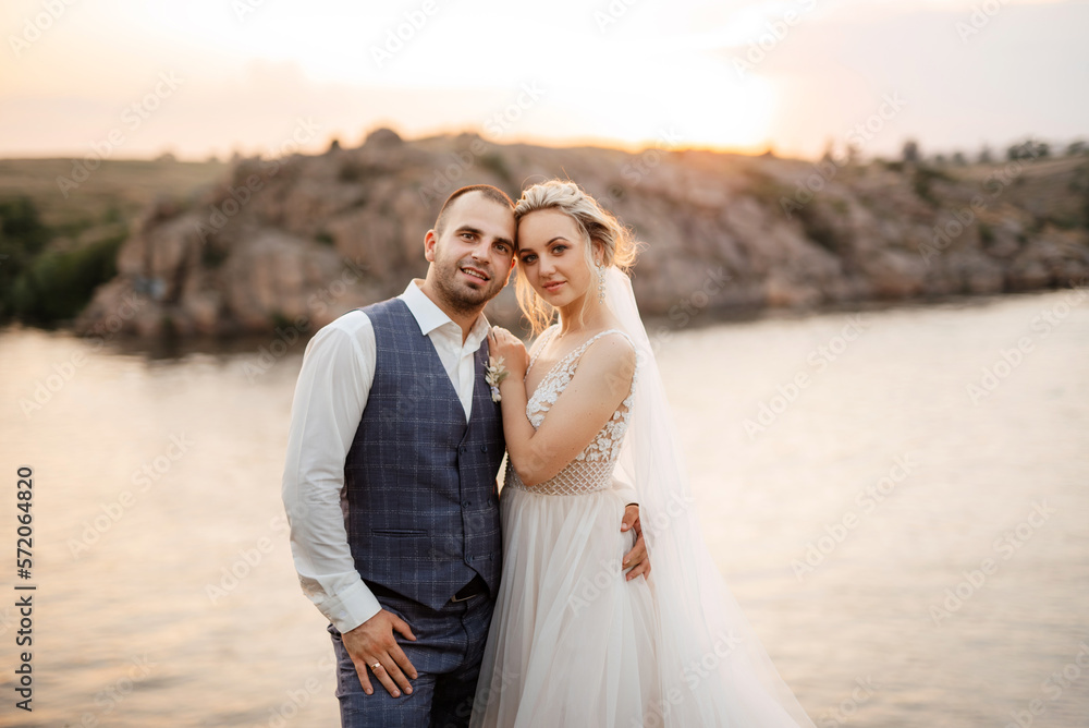 bride blonde girl and groom near the river