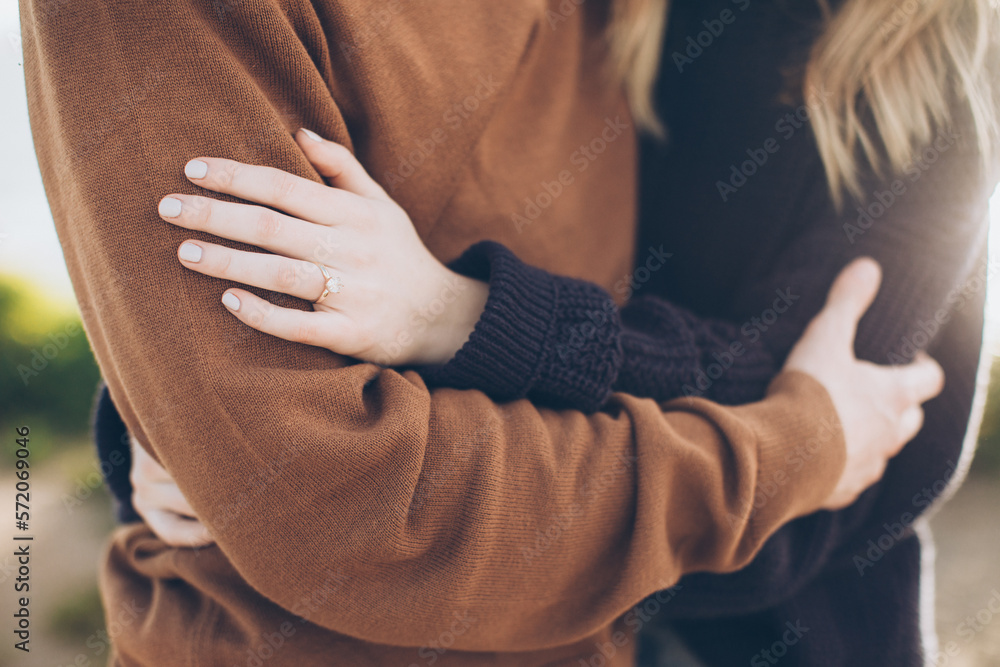 hands of a man and woman after a proposal with close up of a simple diamond ring hands of a man and woman after a proposal with close up of a simple diamond ring