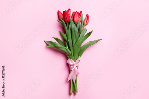 Bouquet of tulips on a pink background. With a pink bow © MM