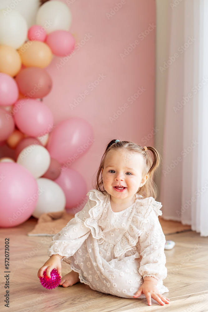 Baby toddler crawls in the room and plays with toys. Concept of childhood and Happy birthday Baby toddler crawls in the room and plays with toys. Concept of childhood and Happy birthday
