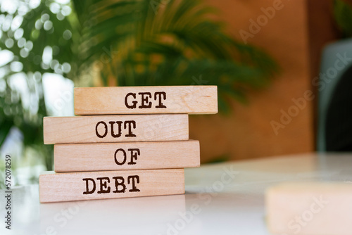 Wooden blocks with words 'Get Out Of Debt'.